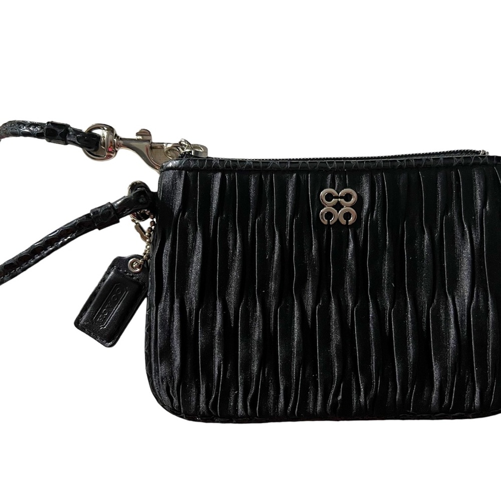 Coach small wristlet.  Black fabric with corner zip closure.  Silver hardware.